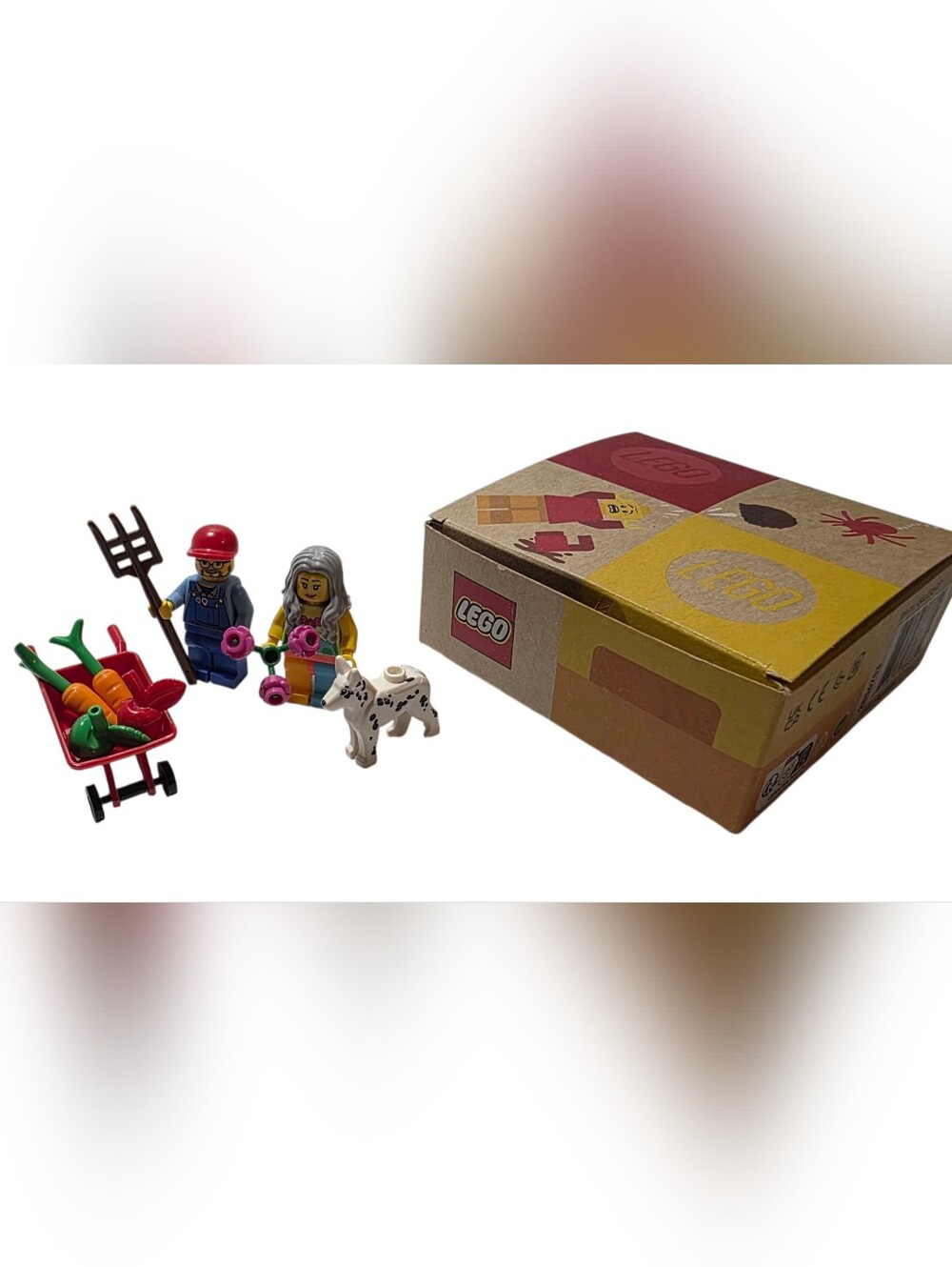 Lego minifigure gardening set with red wheelbarrow, green carrots & spotted dog